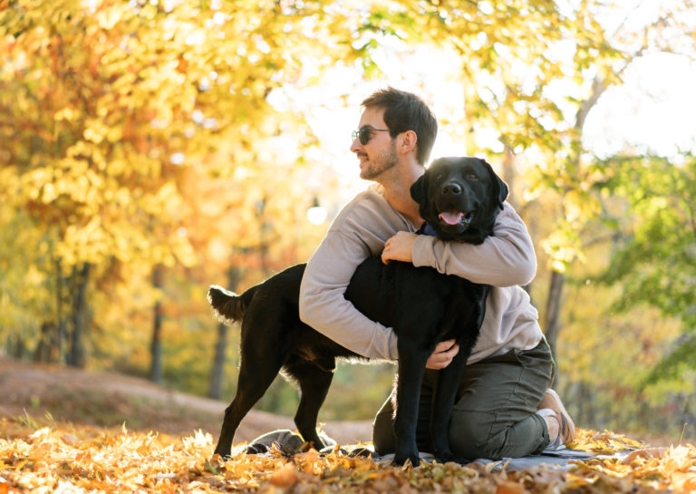 Pet owner reunited with their dog, hugging on the hiking trail after being reunited.